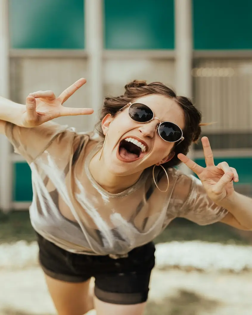 alt="Does Travel Make Your Happier - Lady Smiling."